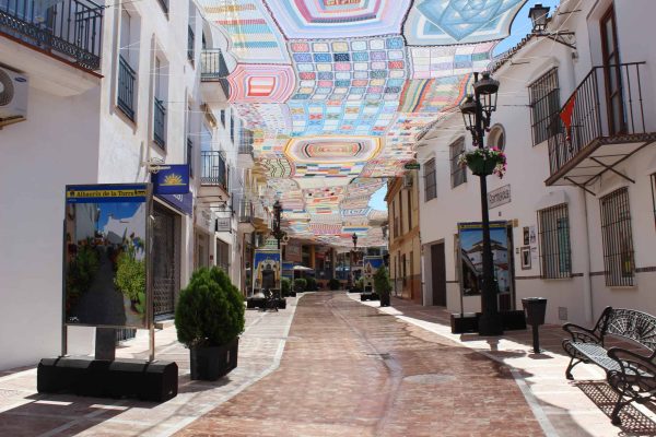 ALHAURIN DE LA TORRE, MALAGA- 25 JUNE 2022:  Alhaurin de la Torre street decorated with a crochet awning