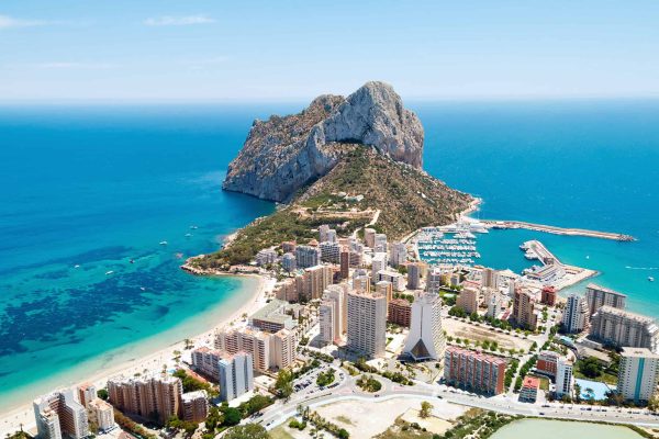 Aerial photography Penyal d'Ifac Natural Park, Calpe townscape turquoise bright Mediterranean Sea waters, residential buildings. Province of Alicante, Costa Blanca, Spain. Travel and landmark concept