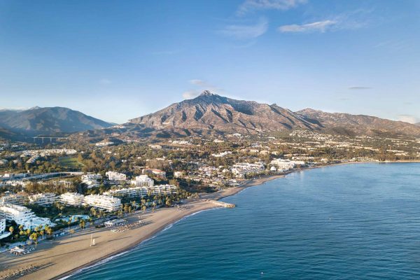 Beautiful aerial Panoramic View of Marbella, Nueva Andalucia and Puerto Banus area. Beautiful colours at sunset. La Concha mountain in background.