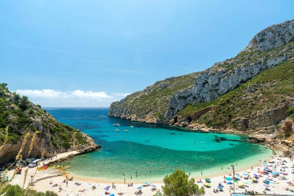 Mediterranean sea and sail of yacht on spanish seaside. Blue lagoon